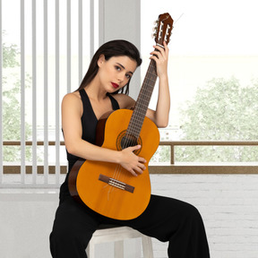 A woman sitting on a stool holding a guitar