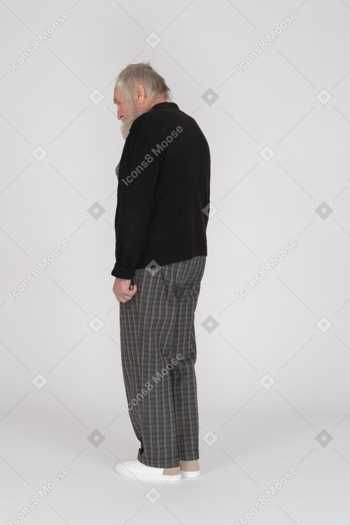 Three quarter back view of an old man standing