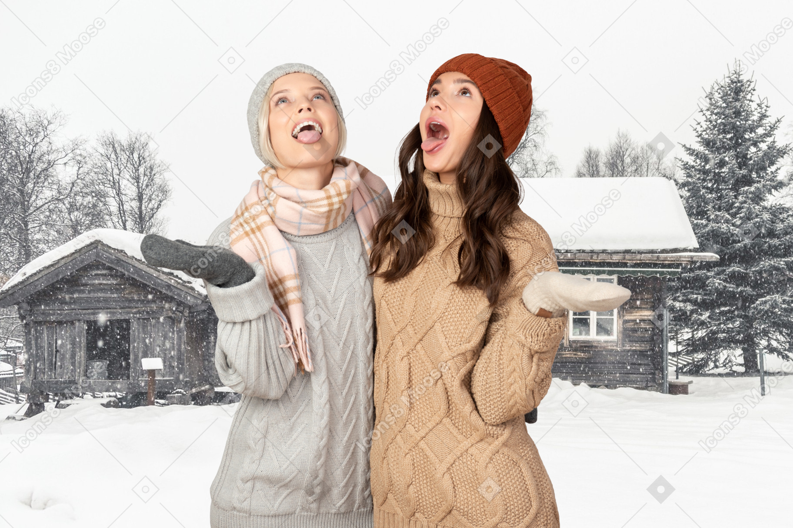 Two friends catching snowflakes with tongues