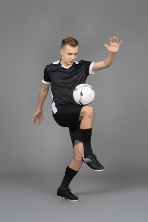 A young sporty man juggling a ball