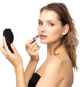 Side view of a young woman applying lipstick while holding a mirror