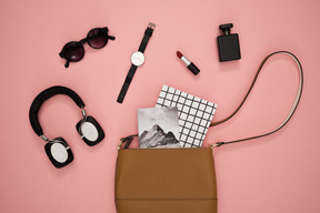 Female bag and accessories on a pink background