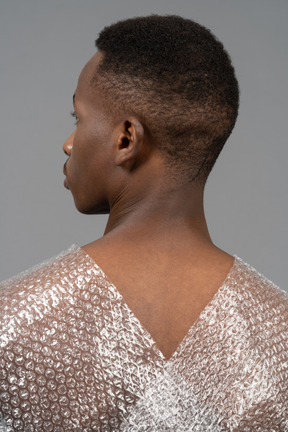 Back view of an african man with a plastic wrap crossing shoulders