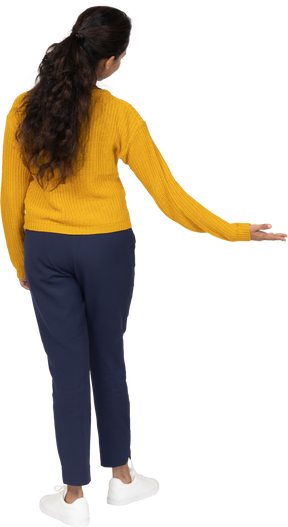 Back view of a girl in casual clothes making welcome gesture