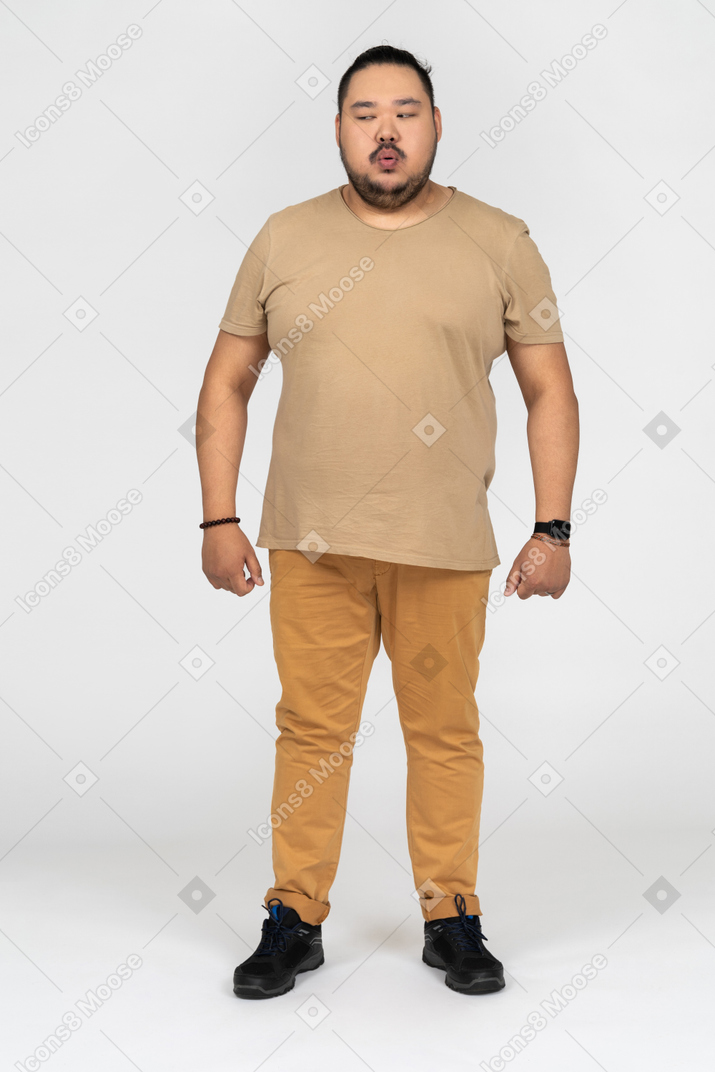 Asian man standing with closed eyes