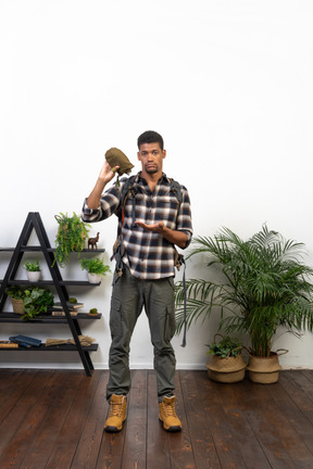 Dehydrated backpacker holding an empty flask