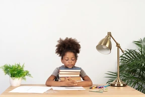 Good looking cute girl with books at the table