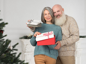 Senior couple exchanging christmas gifts