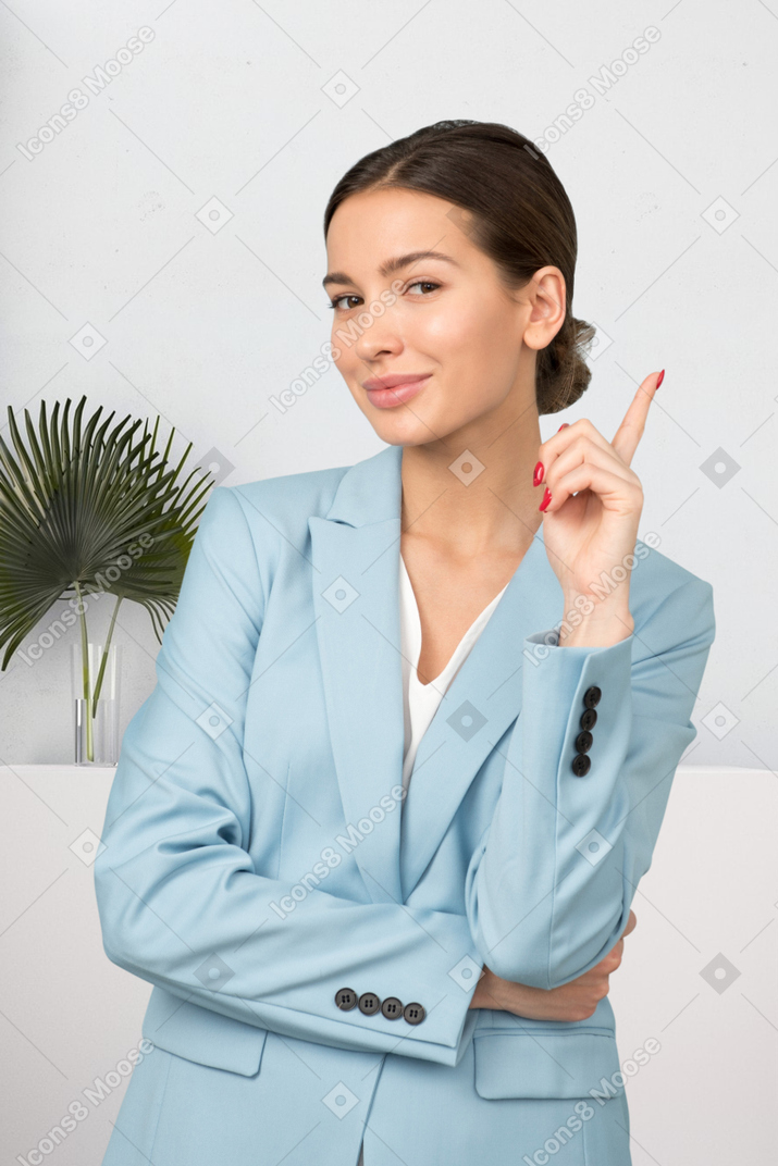 A woman in a blue suit posing for a picture