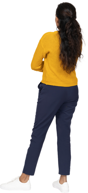 Back view of a girl in casual clothes posing with crossed arms