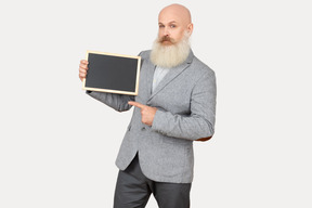 Old professor holding small blackboard