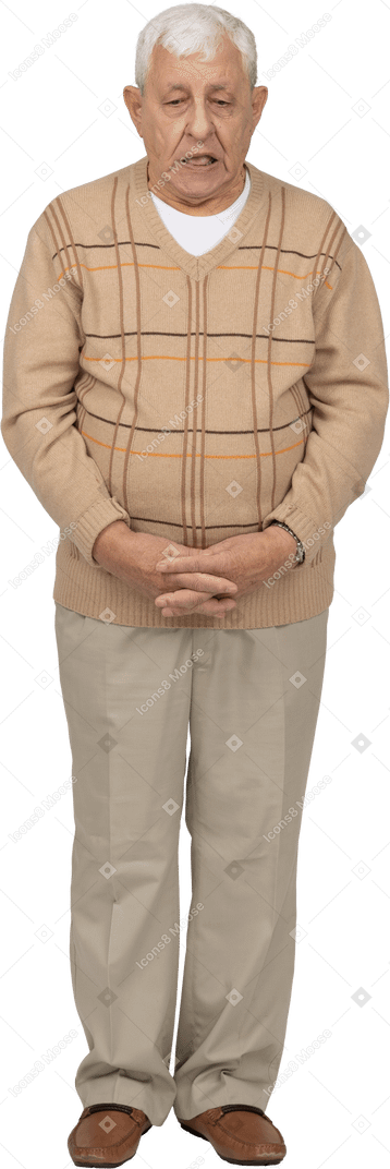 Front view of an old man in casual clothes making faces