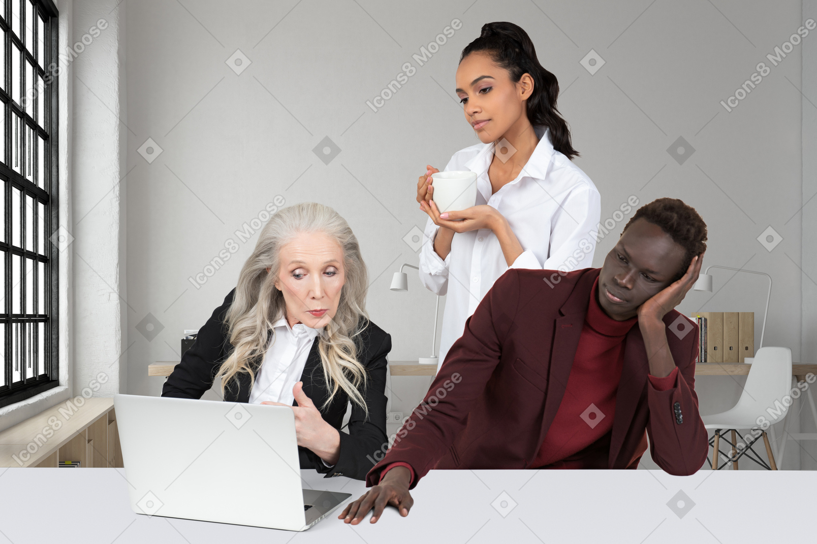 A group of people sitting at a table with laptop