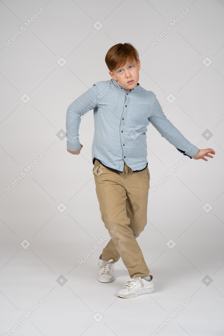 A young boy doing dance moves