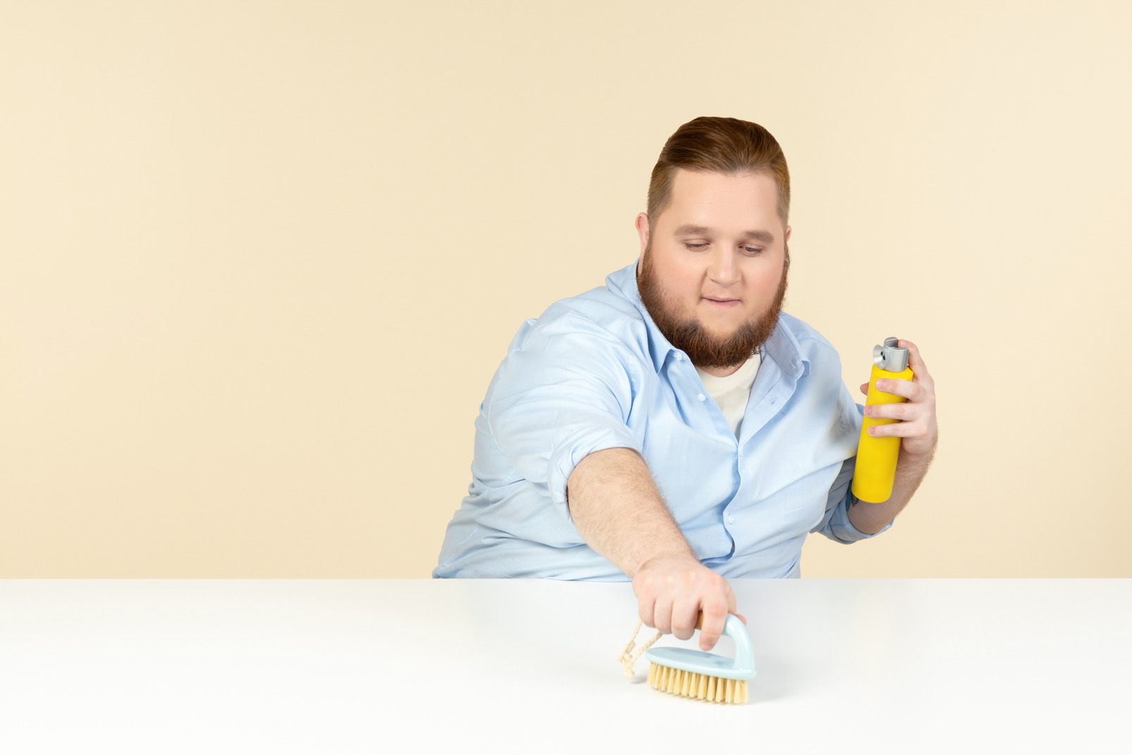 Focused young overweight man cleaning the surface