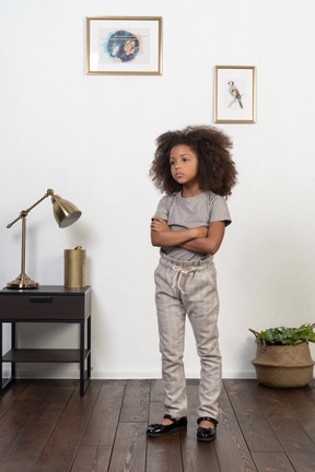 Good looking girl kid posing on the apartment background