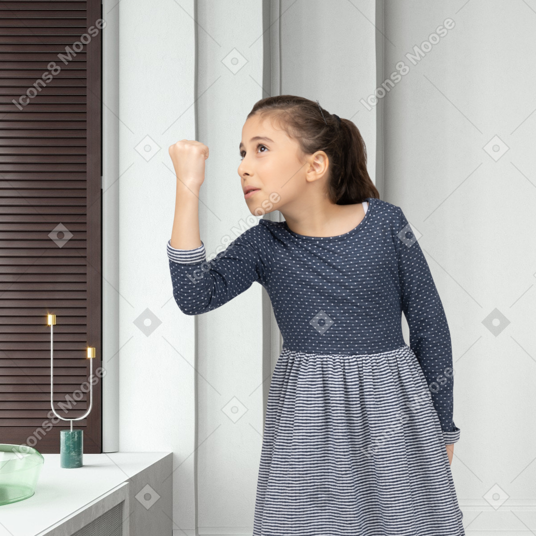 A little girl showing a fist