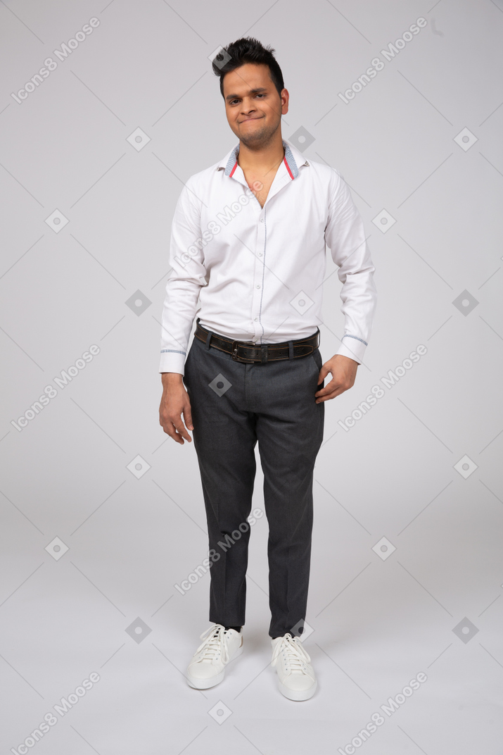 A man in office clothes smiling awkwardly