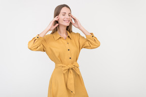 Smiling young woman touching her face