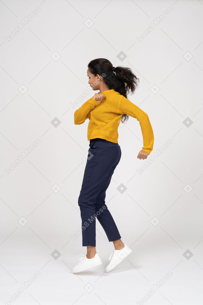 Side view of a girl in casual clothes running