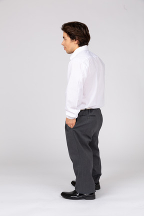 Side view of man with hands in pockets