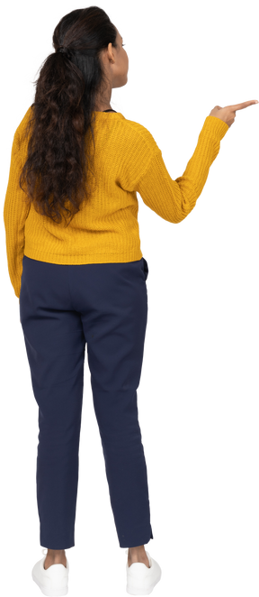 Rear view of a girl in casual clothes pointing with finger