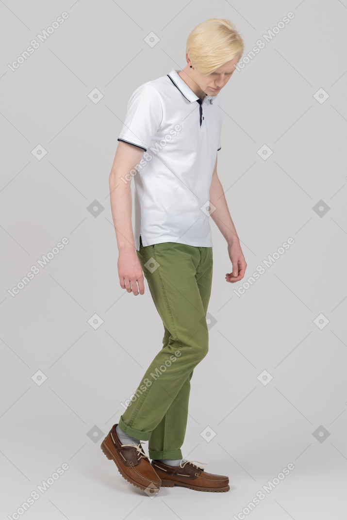 Young man walking and looking down