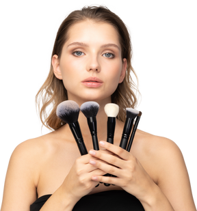 Front view of a sensual young woman holding make-up brushes