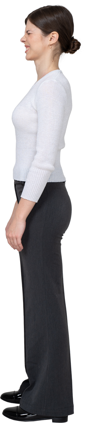 Side view of a grimacing displeased young woman in office clothing