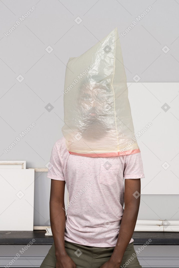 Man sitting with a waste bag over his head