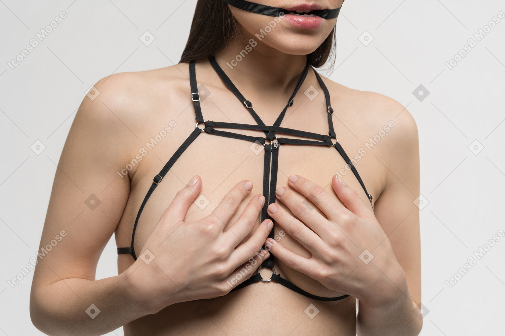Front view of sexy young woman covering breast with hands