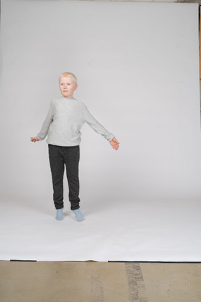 Boy jumping up with his arms spread