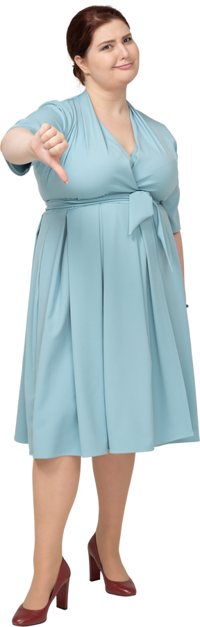 Vista frontal de uma mulher de vestido azul mostrando o polegar para baixo