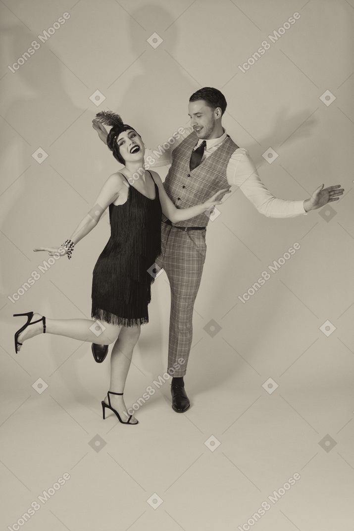 Well-dressed gentleman and lady dancing to the tune