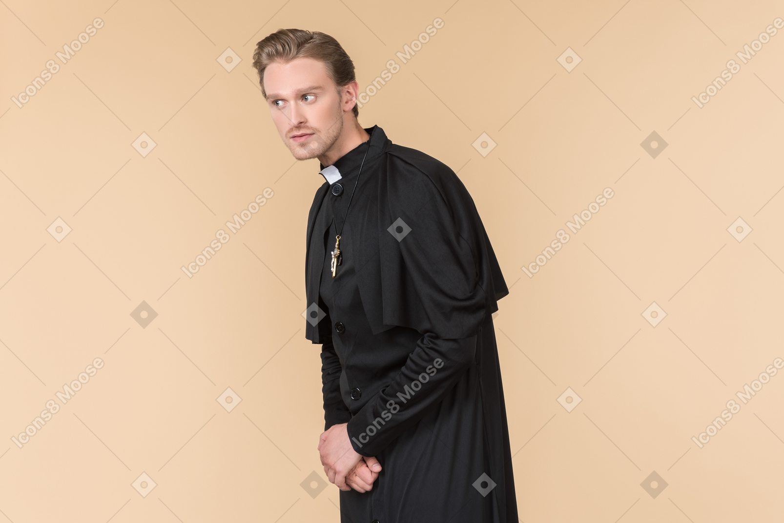 Catholic priest in cassock listening closely to something