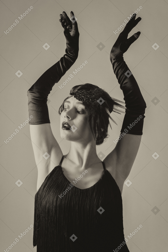 Portrait of a sensual flapper keeping hands up
