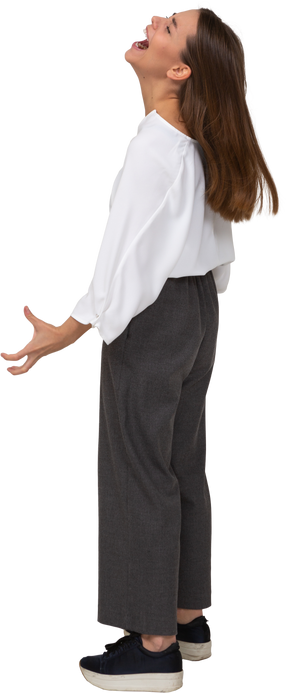 Side view of a mad yelling young lady in office clothing outspreading hands