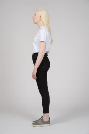 Side view of a teenage girl with arms at sides