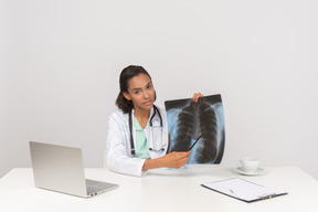 Beautiful female doctor with an x-ray photograph