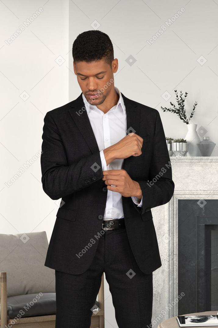 Man in a suit adjusting his sleeve