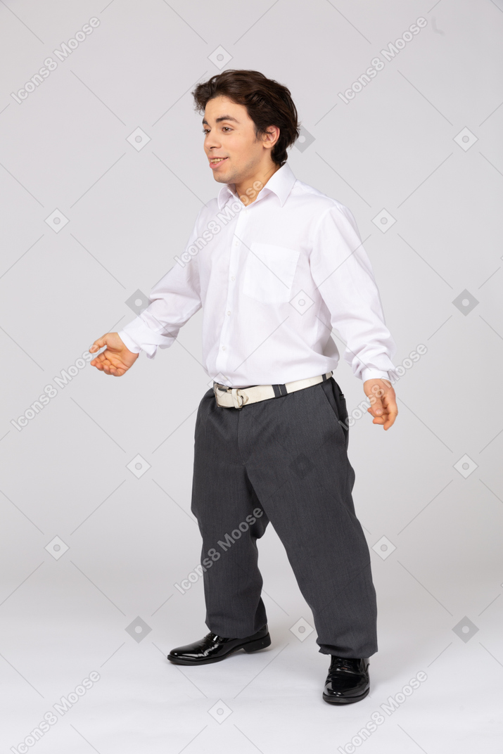 Cheerful young man spreading arms