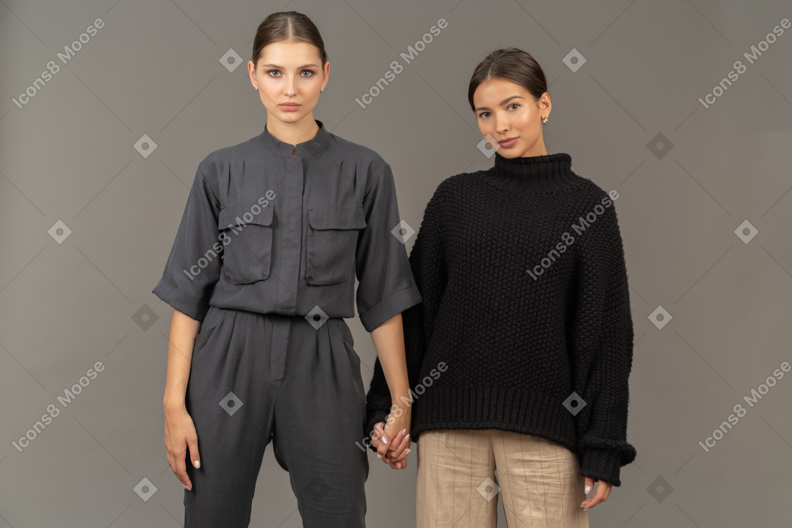 Two women holding hands