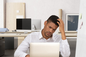 A man sitting in front of a laptop computer