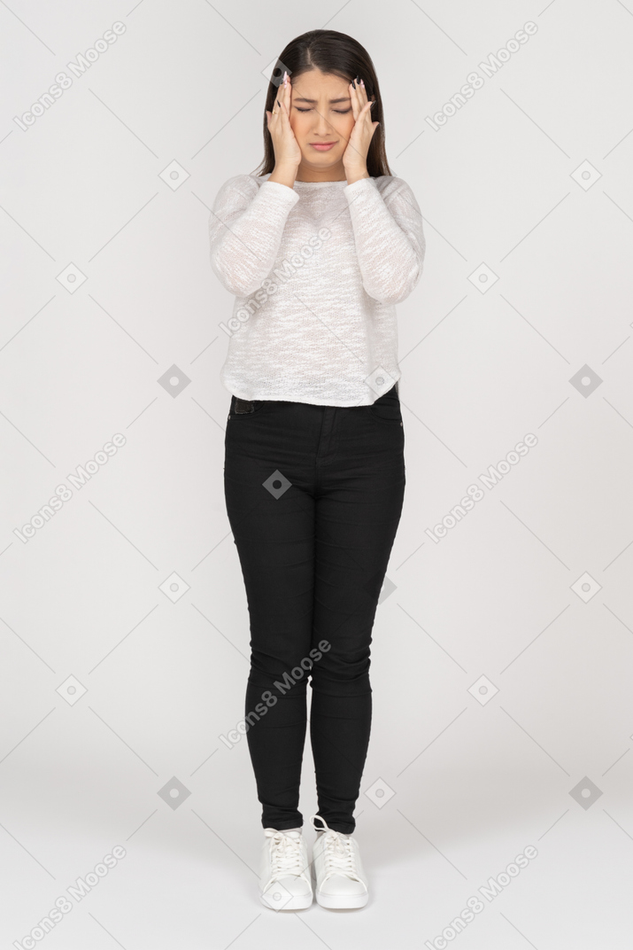 Front view of an anxious young indian female in casual clothes touching head