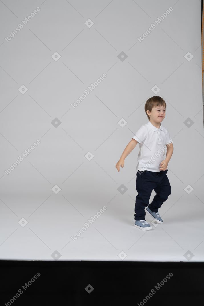 Smiling little boy walking around