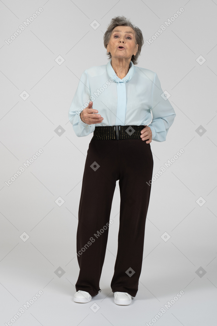 Front view of an old woman explaining animatedly