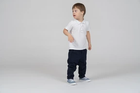 Three-quarter view of a boy looking over his shoulder