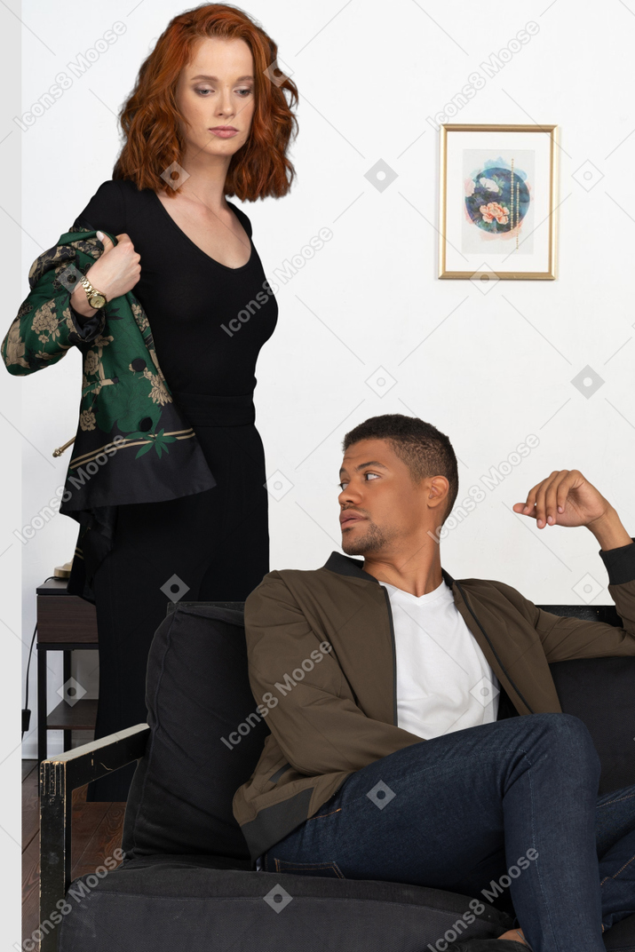 A man sitting on a couch next to a woman