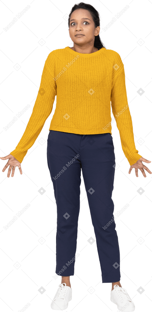 Front view of a confused girl in casual clothes standing with outstretched arms and looking up