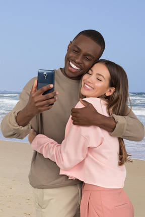A man hugging a woman on the beach